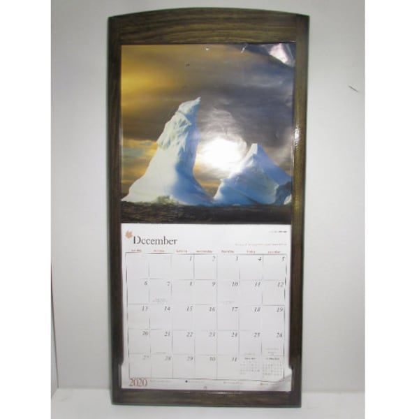 Calendar holder frame for 13.5" X 24" calendar made from solid wood finished with dark walnut stain