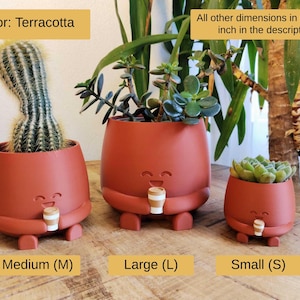May include: Three terracotta-coloured plant pots with smiling faces and small legs. The pots contain succulents and a cactus. Each pot has a small coffee cup. The image text says "Color: Terracotta" and "Medium (M), Large (L), Small (S)".