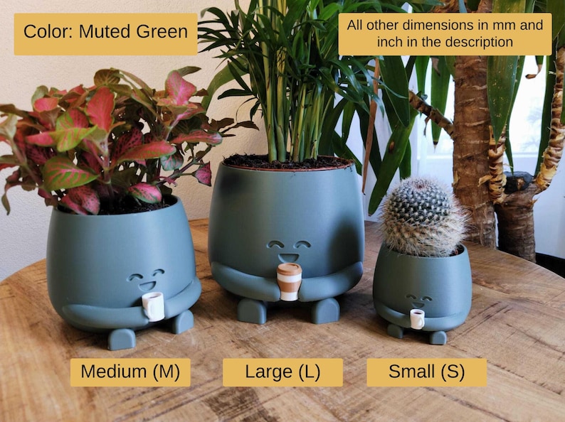 May include: Three muted green plant pots in different sizes, each with a smiling face and holding a small cup. The pots are labelled Medium, Large, and Small, and contain plants. The text "Color: Muted Green" is visible.