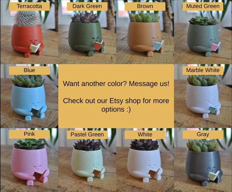 May include: A selection of small, colourful planters, each containing a succulent plant. The planters are in shades like terracotta, dark green, brown, and blue. Each planter has a face and is holding a book. The image text reads "Want another colour? Message us!"