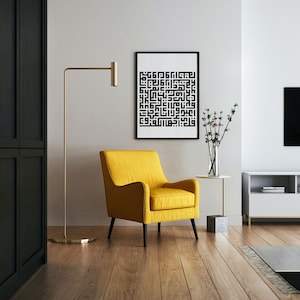 May include: A yellow armchair with black legs sits in a living room with a black and white abstract print on the wall, a gold floor lamp, and a small white side table with a vase of flowers.