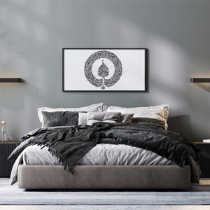 May include: A modern bedroom with a gray wall, a black bed frame, and a black and white framed print of a tree with a circle around it. The bed has a gray duvet and a black throw blanket. There are two black nightstands on either side of the bed.