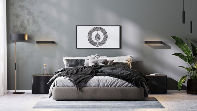 May include: A modern bedroom with a gray wall, a black bed frame, and a black and white framed print of a tree with a circle around it. The bed has a gray duvet and a black throw blanket. There are two black nightstands on either side of the bed.