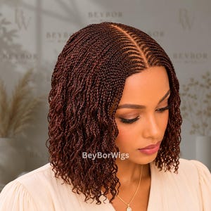 May include: A shoulder-length wig featuring dark auburn micro-braids with a center part and a natural-looking lace front. The hair texture is wavy and uniform throughout. The text BeyBorWigs is visible on the lower portion of the image.