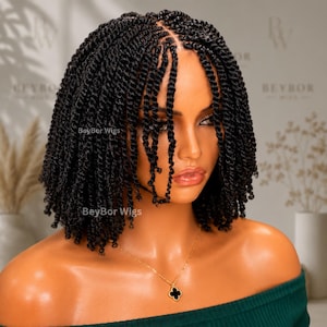 May include: A shoulder-length black wig featuring tightly coiled twists throughout. The hair is styled with a center part, and the text BeyBor Wigs is visible on the image. The wig is displayed on a mannequin with a smooth complexion and a gold necklace.