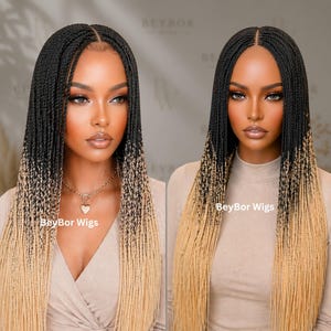 May include: A long, straight wig featuring black roots that transition into a light blonde ombre color. The hair is styled in thin, uniform micro-braids with a center part. The text BeyBor Wigs is visible on the lower portion of the hair.