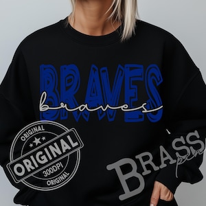 May include: Black sweatshirt with the word "BRAVES" in blue block letters and "braves" in a cursive font underneath. The sweatshirt also has a "ORIGINAL" stamp and the word "BRASS" on the sleeve.