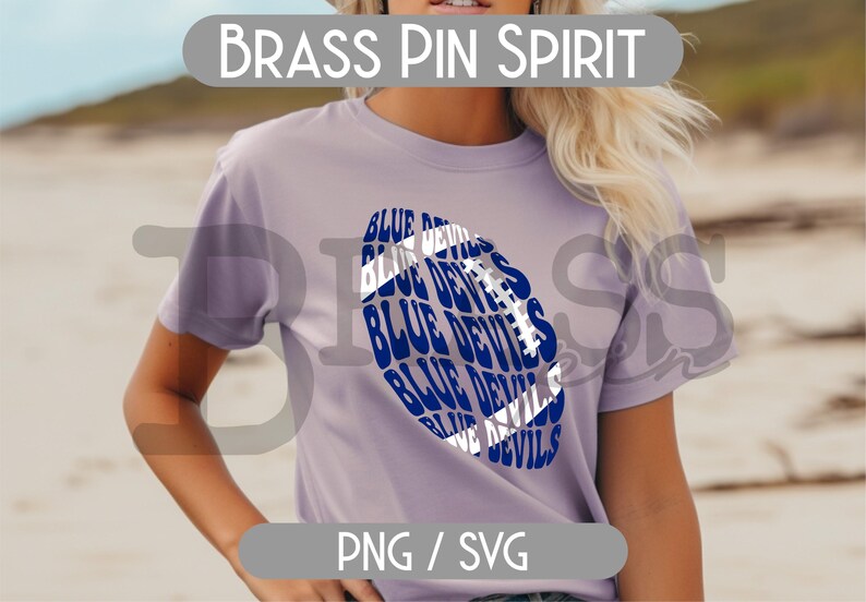 May include: A light purple t-shirt featuring a blue and white football design with the words "BLUE DEVILS" repeated throughout. The text "BRASS PIN SPIRIT" is above the shirt design. The bottom of the shirt has the text "PNG / SVG".