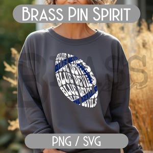 May include: A dark gray sweatshirt with a football-shaped graphic. The graphic features the words "BLUE DEVILS" in white and blue. The text "BRASS PIN SPIRIT" is above the sweatshirt, and "PNG / SVG" is below.