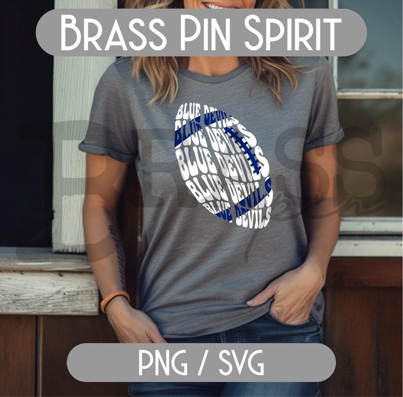 May include: A gray t-shirt with a football graphic that says "Blue Devils" in white and blue. The shirt has rolled-up sleeves and the text "Brass Pin Spirit" at the top.