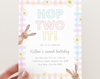 May include: A pastel-colored birthday invitation with the text "HOP TWO IT!" and "Willow's second birthday." The invitation features a gingham pattern, daisies, and illustrations of bunnies wearing party hats. The invitation is held by a hand.