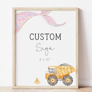 May include: A framed print with the words "CUSTOM Sign" in black lettering. The print includes a watercolor illustration of a yellow dump truck, a traffic cone, and a mermaid tail. The sign measures 8 x 10 inches.