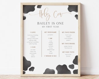May include: A printable poster with a cow print background and the text "Holy Cow Bailey is One My First Year". The poster lists the child's favorite things, including foods, books, and toys.