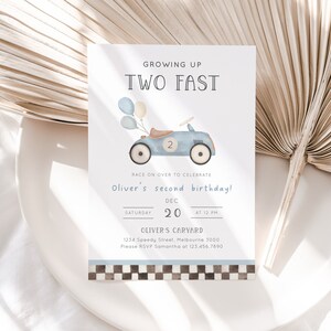 May include: A blue and white birthday invitation with a cartoon illustration of a blue toy car with balloons. The text reads "Growing Up Two Fast" and "Oliver's second birthday!" with the date and time of the party.