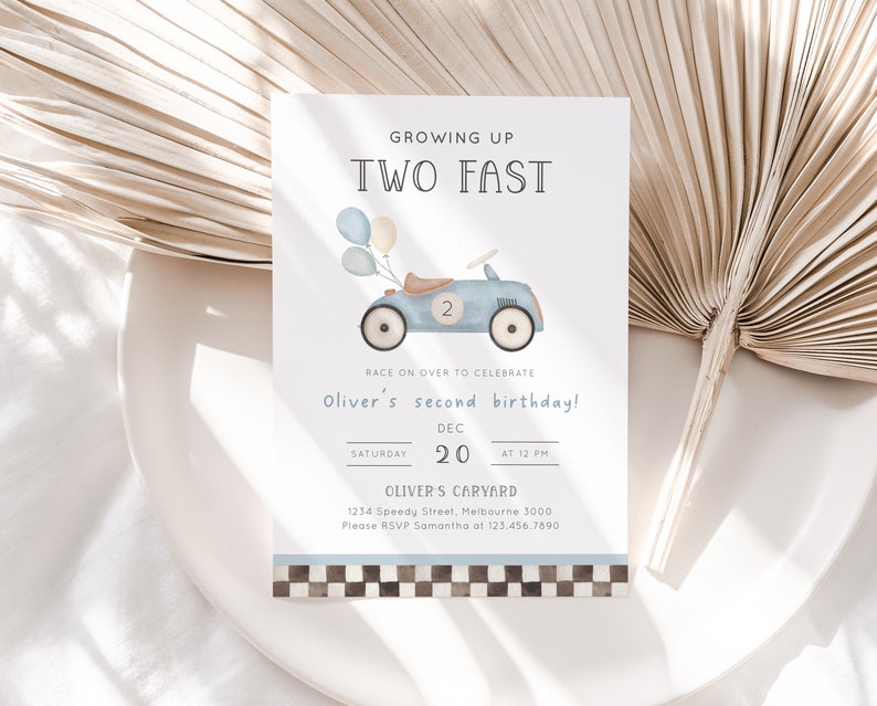 May include: A blue and white birthday invitation with a cartoon illustration of a blue toy car with balloons. The text reads "Growing Up Two Fast" and "Oliver's second birthday!" with the date and time of the party.