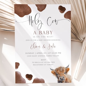 May include: A white baby shower invitation with brown cow print spots. The text reads "Holy Cow, A Baby is on the Way!" and includes the names "Elena & Jake" and details for the shower.