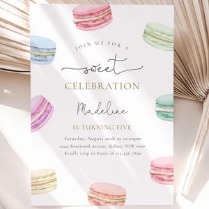 May include: A pastel pink, blue, and green birthday invitation with a watercolor illustration of macarons. The invitation reads "Join us for a sweet celebration Madeline is turning five. Saturday, August 20th at 12:00pm 12345 Rosewood Avenue, Sydney, NSW 2000. Kindly rsvp to Katie at 123.456.7890"