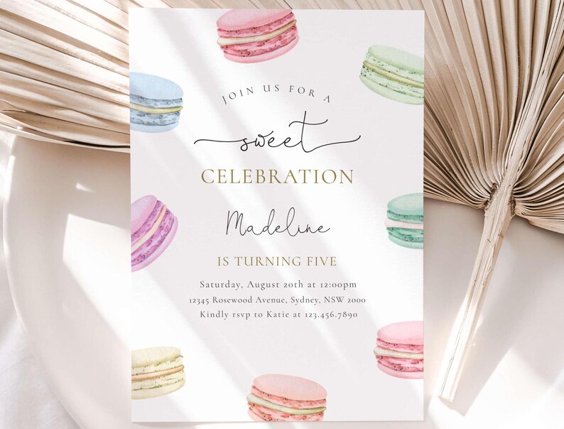 May include: A pastel pink, blue, and green birthday invitation with a watercolor illustration of macarons. The invitation reads "Join us for a sweet celebration Madeline is turning five. Saturday, August 20th at 12:00pm 12345 Rosewood Avenue, Sydney, NSW 2000. Kindly rsvp to Katie at 123.456.7890"