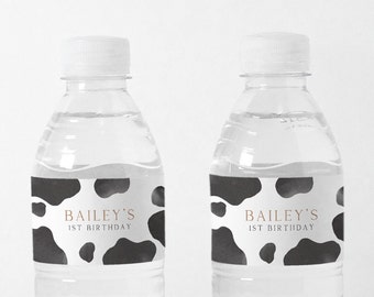 May include: Two clear plastic water bottles with black and white cow print labels that say "Bailey's 1st Birthday".