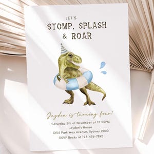 May include: A white invitation card featuring a green dinosaur in a party hat and a blue and white striped swim ring. The text "LET'S STOMP, SPLASH & ROAR" is at the top. The text "Jayden is turning four!" is below the illustration.