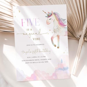 May include: A birthday invitation with a watercolor unicorn illustration. The text reads "FIVE is a magical VIBE" in a mix of fonts. Additional text includes the birthday girl's name, date, time, and address.