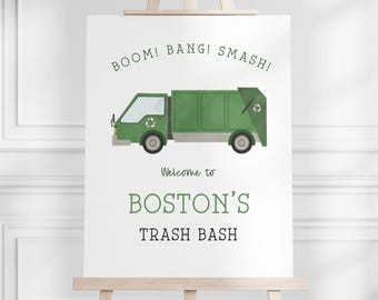 May include: A white sign with green text that reads "BOOM! BANG! SMASH!" and a green cartoon garbage truck. The sign also says "Welcome to Boston's Trash Bash".