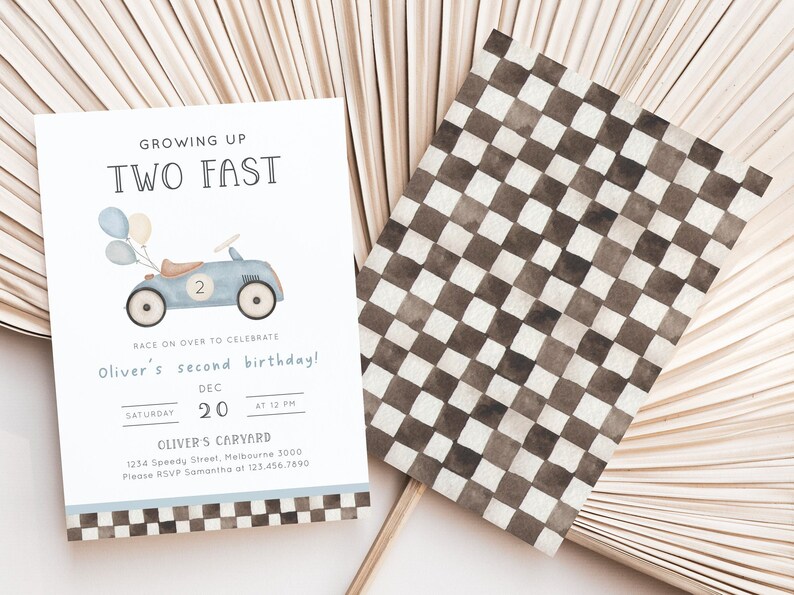 May include: A blue and white birthday invitation with a cartoon car and balloons. The text reads "Growing Up Two Fast" and "Oliver's second birthday!" with the date and time of the party. The invitation also includes the address and RSVP information.