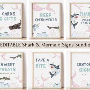 May include: A collection of framed signs with a shark and mermaid theme. The signs feature watercolor illustrations of sharks, mermaid tails, and coral, with text such as "Cards & Gifts" and "Sweet Treats". The signs are in a light wood frame.