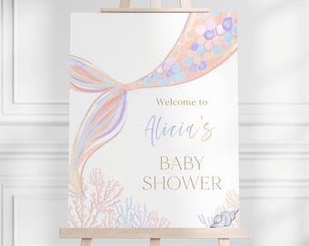 May include: A welcome sign for a baby shower with a pastel pink, purple, and blue mermaid tail with gold glitter accents. The text reads "Welcome to Alicia's Baby Shower".