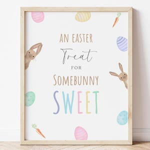 May include: A white printable sign with the text "An Easter Treat for Somebunny Sweet" in brown and rainbow colours. The sign is decorated with cartoon bunnies and colourful Easter eggs.