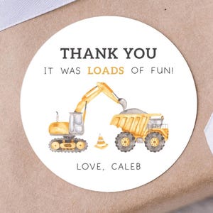 May include: Round thank you sticker with a yellow excavator and dump truck. The sticker says "Thank You It Was Loads Of Fun! Love, Caleb"