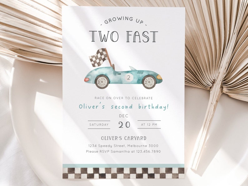 May include: A blue and white race car birthday invitation with a checkered flag. The invitation says "Growing Up Two Fast" and "Oliver's second birthday!" with the date and time of the party. The invitation also includes the address and RSVP information.