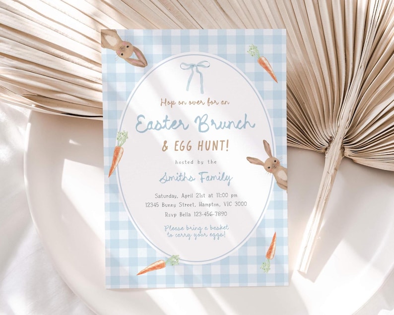 May include: Easter brunch invitation with a light blue gingham background. The invitation features an oval frame with text, bunny illustrations, and carrot accents. The text reads "Hop on over for an Easter Brunch & Egg Hunt!" and includes event details.