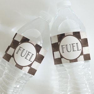 May include: Two clear plastic water bottles with brown and white checkered labels that say "FUEL" in black text.