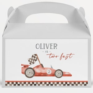 May include: Red and white race car party favor box with a checkered flag and the text "Oliver is two fast".