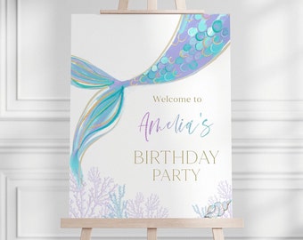 May include: A white sign with a purple and blue mermaid tail illustration. The sign says "Welcome to Amelia's Birthday Party".