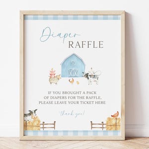 May include: A framed sign with a light blue gingham border. The sign reads "Diaper Raffle" with a watercolor illustration of a barn, farm animals, and text that says "If you brought a pack of diapers for the raffle, please leave your ticket here."