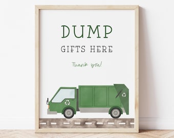Puede incluir: Impresión enmarcada con las palabras "DUMP GIFTS HERE" en texto verde y negro. Debajo, una ilustración de un camión de basura verde sobre una carretera. Las palabras "Thank you!" están escritas en verde debajo.