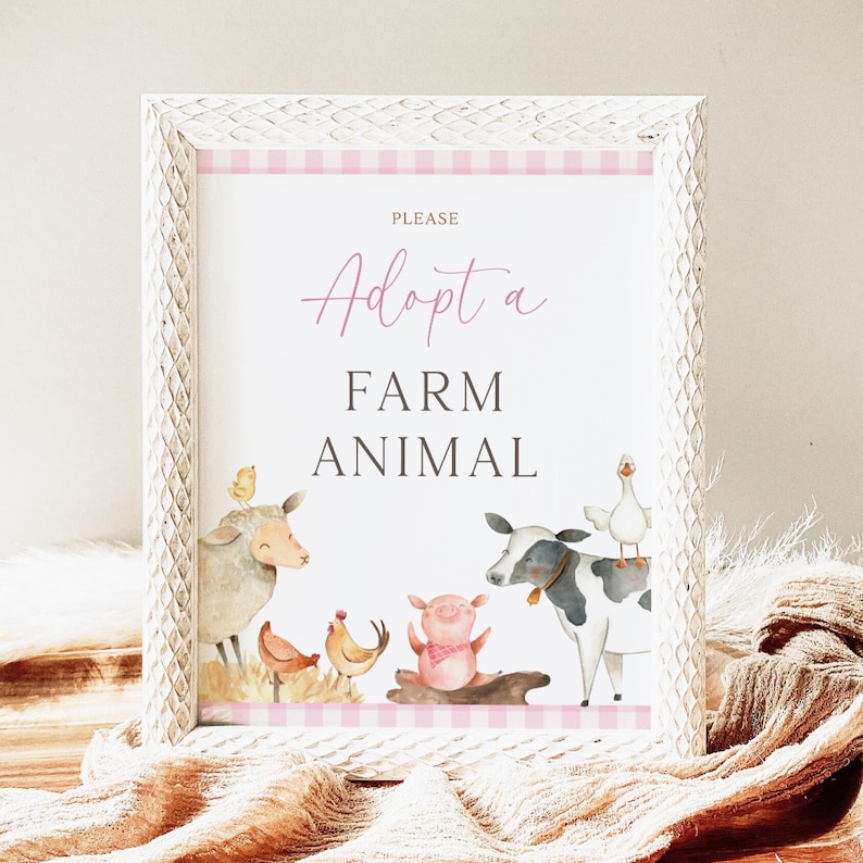 May include: White framed sign with pink and white checkered border. The sign says "Please Adopt a Farm Animal" in black text. The sign features watercolor illustrations of farm animals including a sheep, a cow, a pig, a chicken, and a goose.
