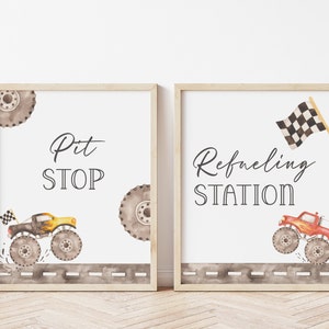 May include: Two printable signs with a monster truck theme. The first sign says "Pit Stop" and features a yellow monster truck with a checkered flag. The second sign says "Refueling Station" and features a red monster truck with a checkered flag.