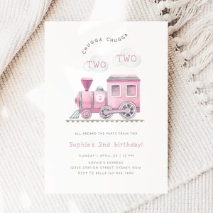 May include: Pink watercolor train with the words "Chugga Chugga Two Two" above it. The train has a number "2" on the side. The text below the train says "All aboard the party train for Sophie's 2nd birthday! Sunday | April 23 | 12 PM Sophie's Express 12345 Station Street, Sydney, NSW RSVP to Bella 123-456-7890"