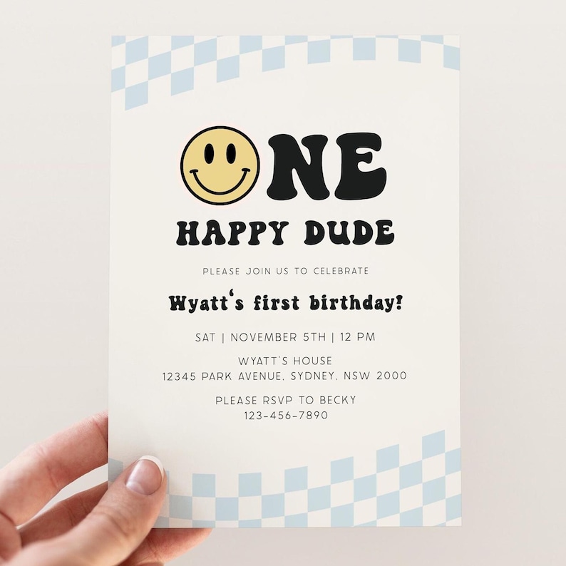 May include: A white invitation with a blue and white checkered border. The invitation says "One Happy Dude" with a yellow smiley face. The text also includes "Please join us to celebrate Wyatt's first birthday!" with the date and time of the party, the address, and RSVP information.