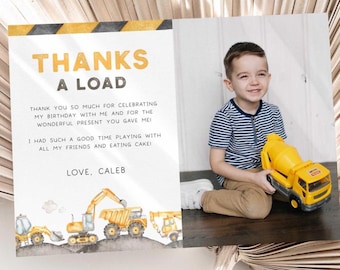 May include: A birthday thank you card with a construction theme. The card features a watercolor illustration of construction vehicles and the text "THANKS A LOAD". A young boy is holding a yellow toy cement mixer.