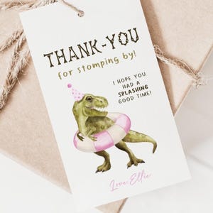 May include: A white gift tag featuring a green dinosaur in a party hat and a pink and white inflatable ring. The tag says "THANK-YOU for stomping by! I HOPE YOU HAD A SPLASHING GOOD TIME! Love, Ellie."