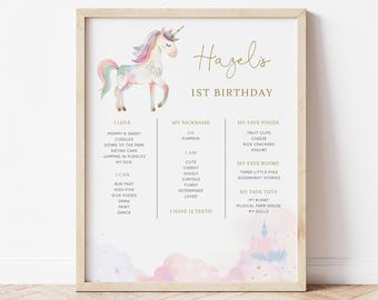 May include: A printable 1st birthday poster featuring a watercolor unicorn with a pink, blue, and purple mane and tail. The poster includes a list of things the child loves, can do, and their favorite foods, books, and toys. The text on the poster reads "Hagelis 1st Birthday".