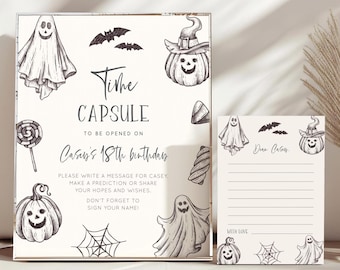 May include: A Halloween-themed time capsule set. The box and card feature illustrations of ghosts, bats, pumpkins, and spiderwebs. The box reads "Time Capsule" and "Casey's 18th birthday". The card is lined for writing a message.