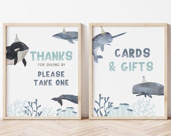 May include: Two printable signs with a nautical theme. The left sign says "Thanks for diving by, please take one" and features a whale, an orca, and coral. The right sign says "Cards & Gifts" and features a narwhal, a whale, and coral.