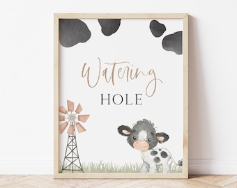 Peut inclure: Une affiche imprimable avec une vache noire et blanche, un moulin à vent et le texte "Watering Hole" en lettres brunes. Le fond est blanc avec des taches de vache noires.