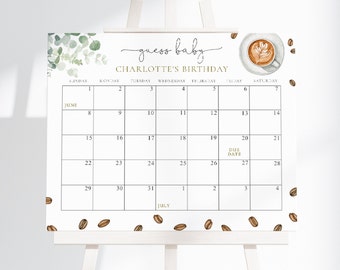 May include: A white calendar with a gold border and the text "guess baby CHARLOTTE'S BIRTHDAY" at the top. The calendar is for June and July and has a due date marked on June 27th. There are coffee beans and a cup of coffee with latte art at the top of the calendar.