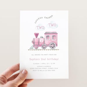 May include: Pink train birthday party invitation with the text "CHUGGA CHUGGA TWO TWO" and a pink train with a number 2 on the side. The invitation says "All aboard the party train for Sophie's 2nd birthday!" and includes the date, time, and RSVP information.